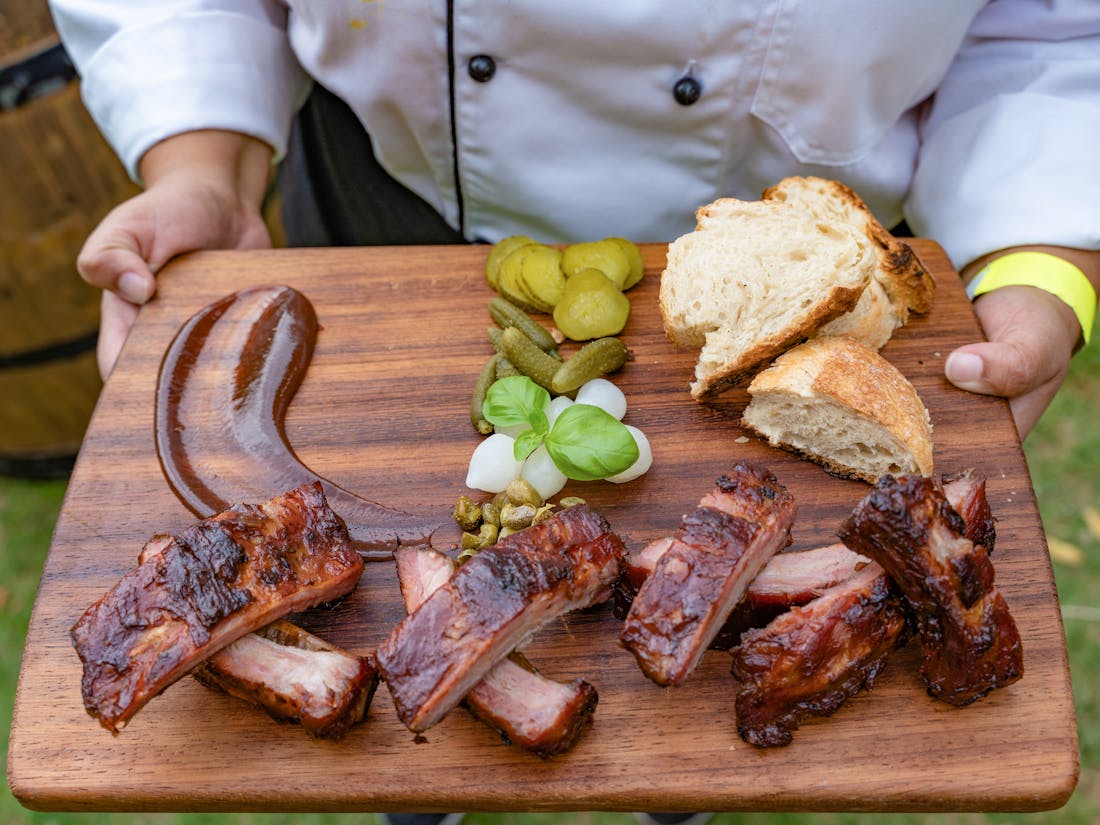 Smoked brisket and barbecue sides being served at an outdoor catered event - the kind of spread Catertoo is built to help manage.
