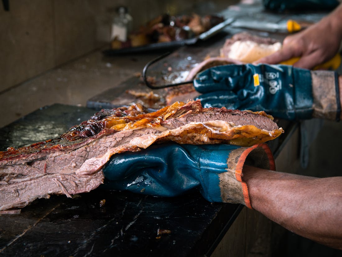 Brisket resting on a smoker, ready to portion for an event