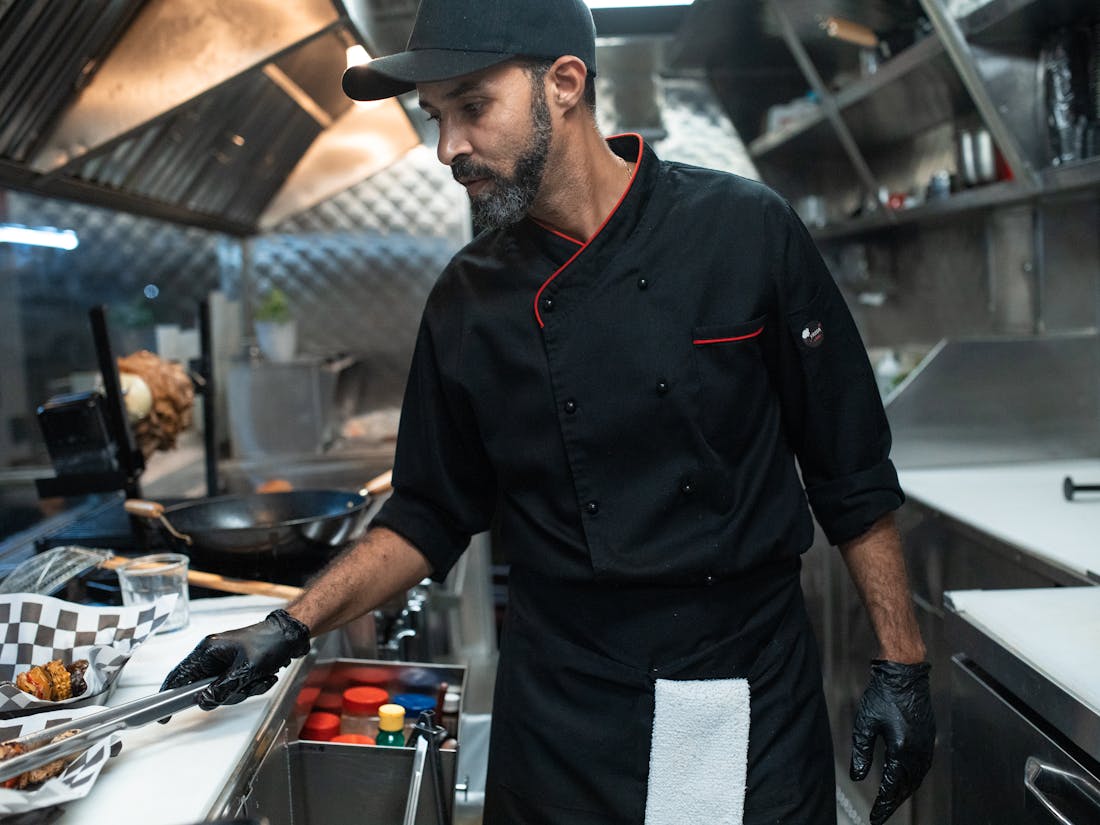 A caterer prepping orders in a compact kitchen