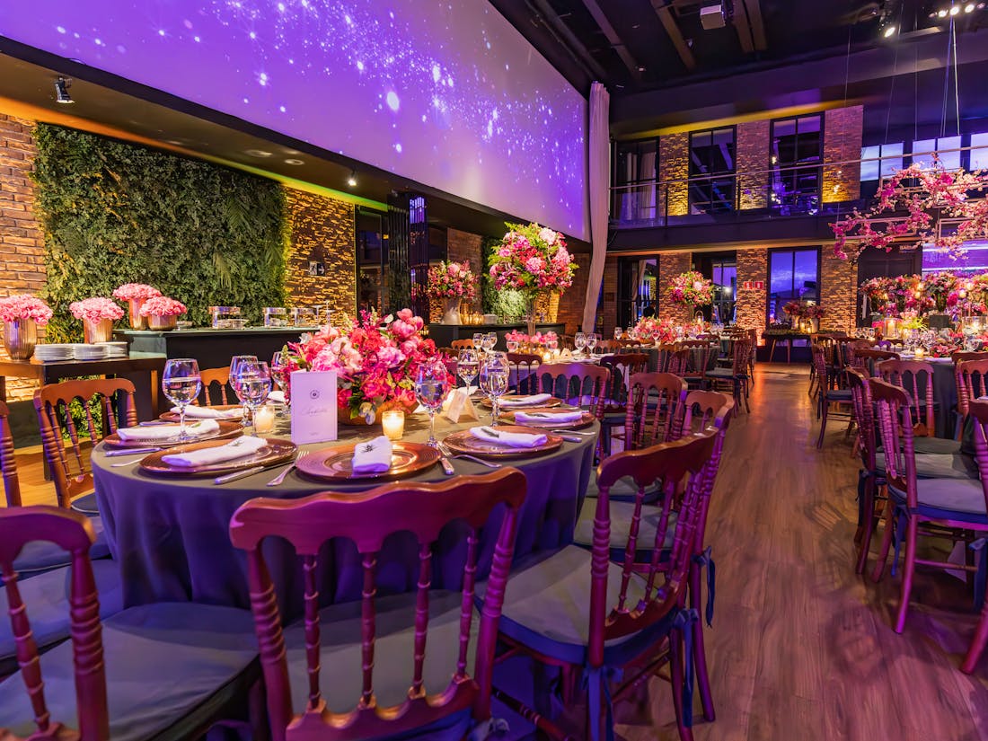 A banquet hall set for a nonprofit gala with elegant table linens, candelabras, and plated catering service.